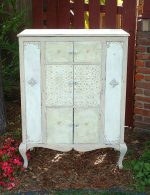 Ivory and peach flip-top cabinet with six doors; pre-1920.